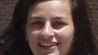 Dr Kirvalidze has long dark hair and is smiling at the camera