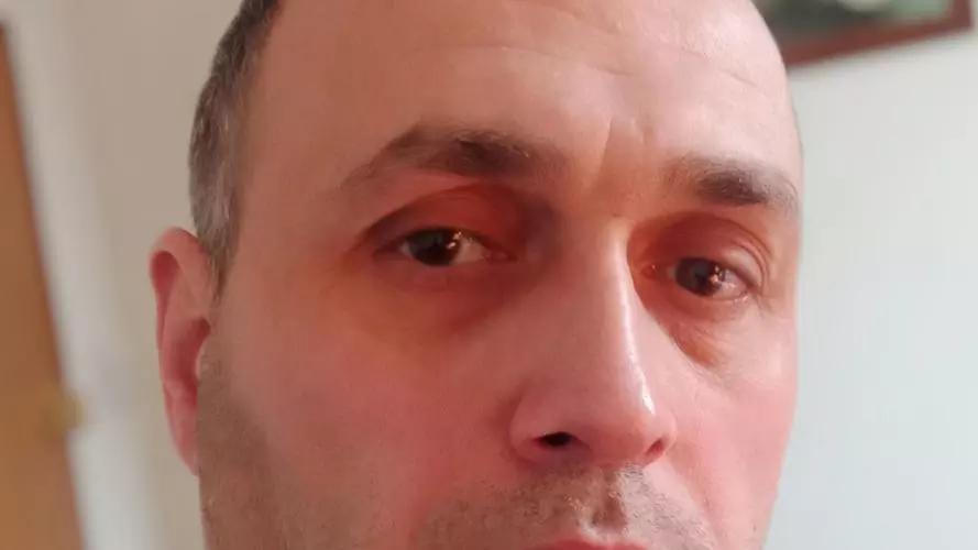 Dr Giorgi Macharashvili has short hair and is wearing a dark blue t-shirt.