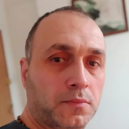 Dr Giorgi Macharashvili has short hair and is wearing a dark blue t-shirt.