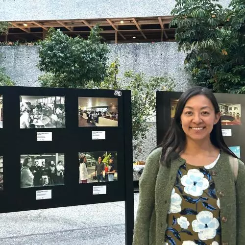 Jessica Fernandez de la Harada standing in front of exhibition board 