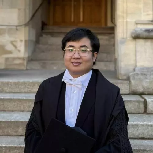 DPhil student in Area Studies, Thu Htet, stands in front of the Radcliffe Camera wearing sub fusc